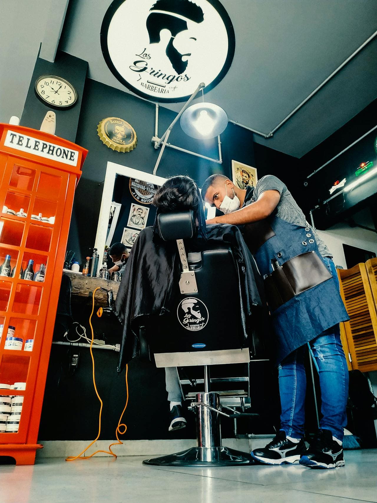 Barber working in a vivid shop scene with strong ambient details