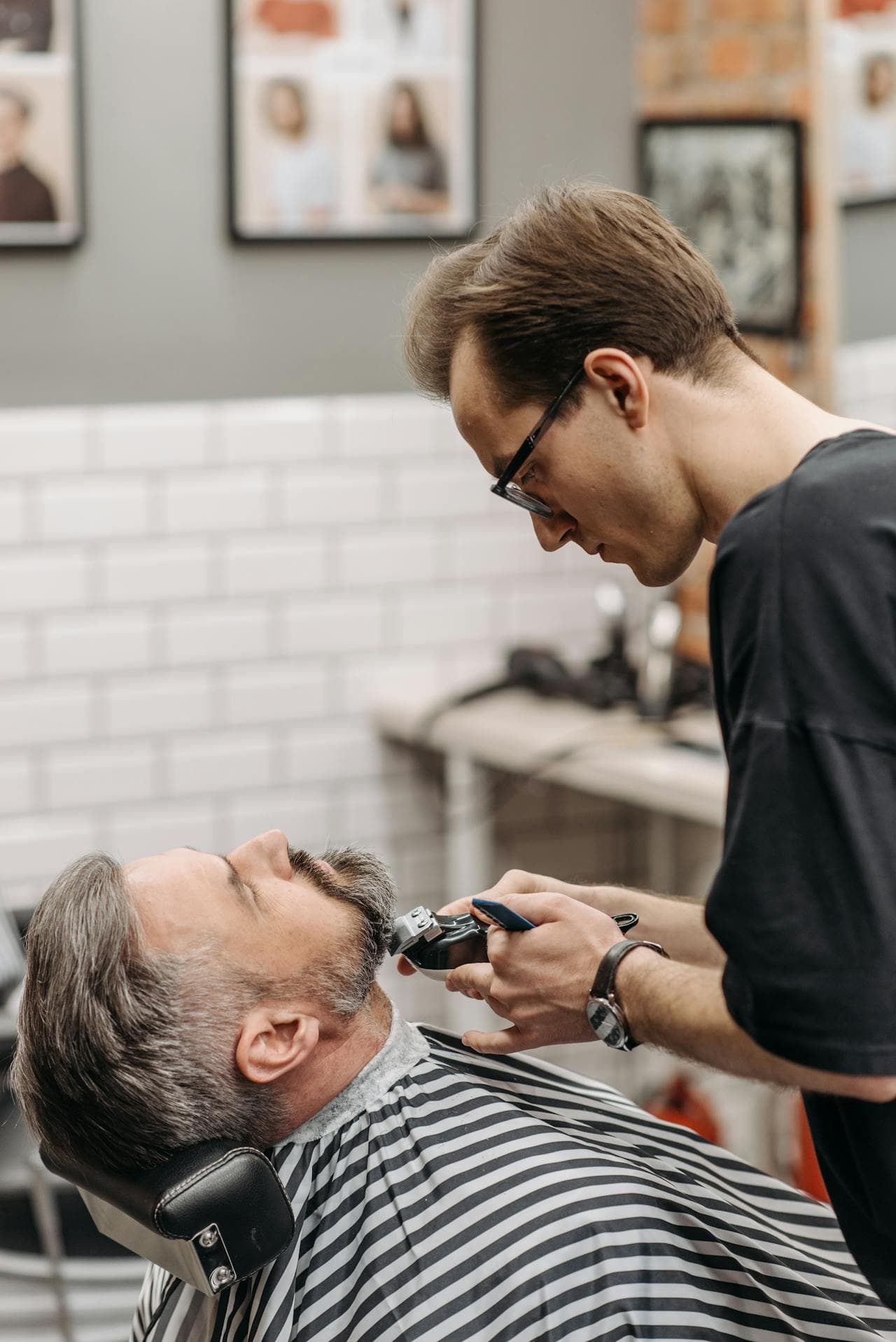 Barber refining a beard line with careful shaping.