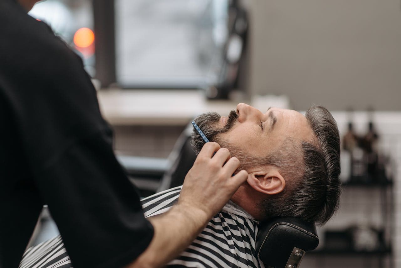 Detailed beard trimming and sculpting in progress.