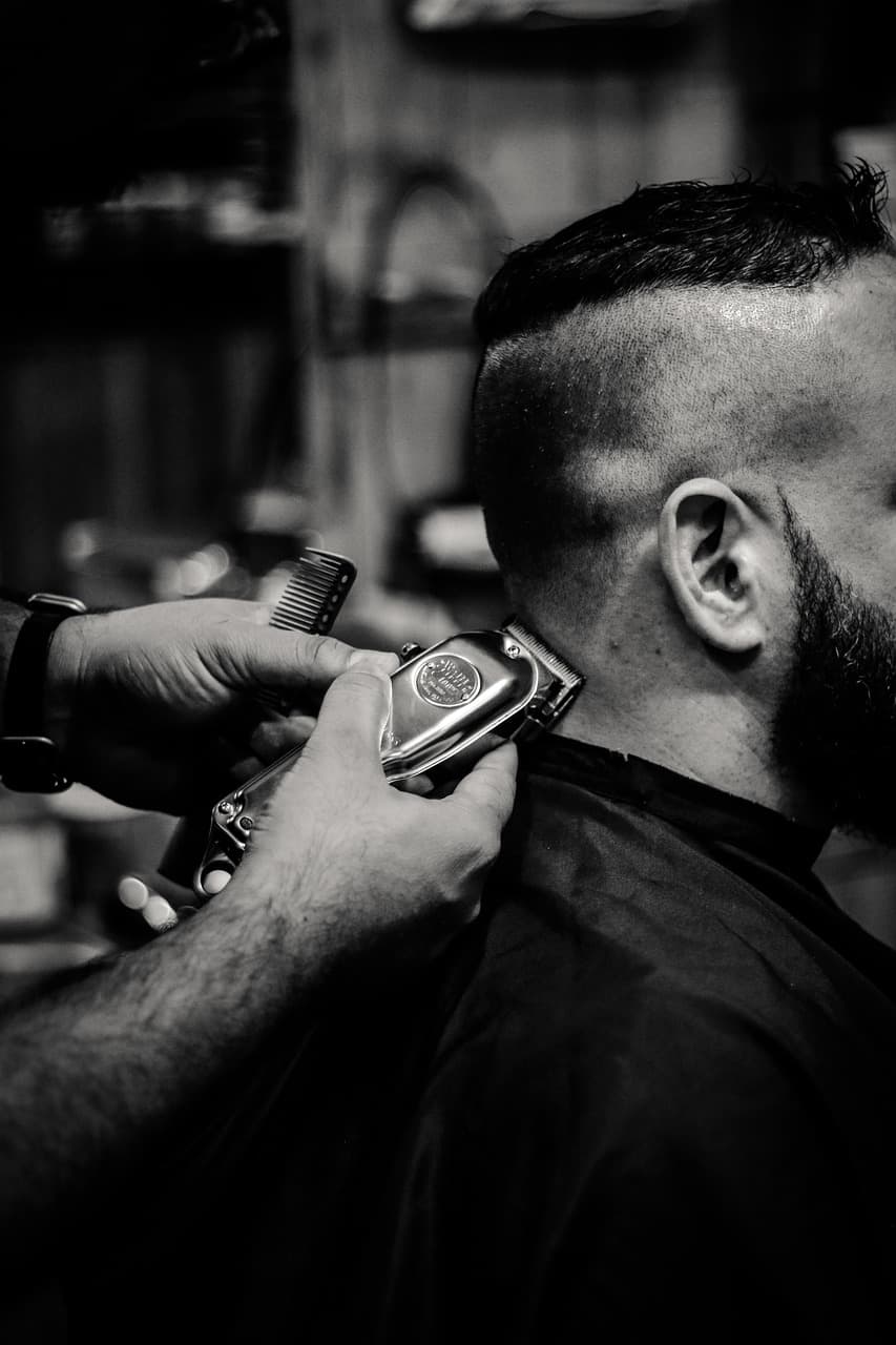 Barber preparing a textured style in the chair.