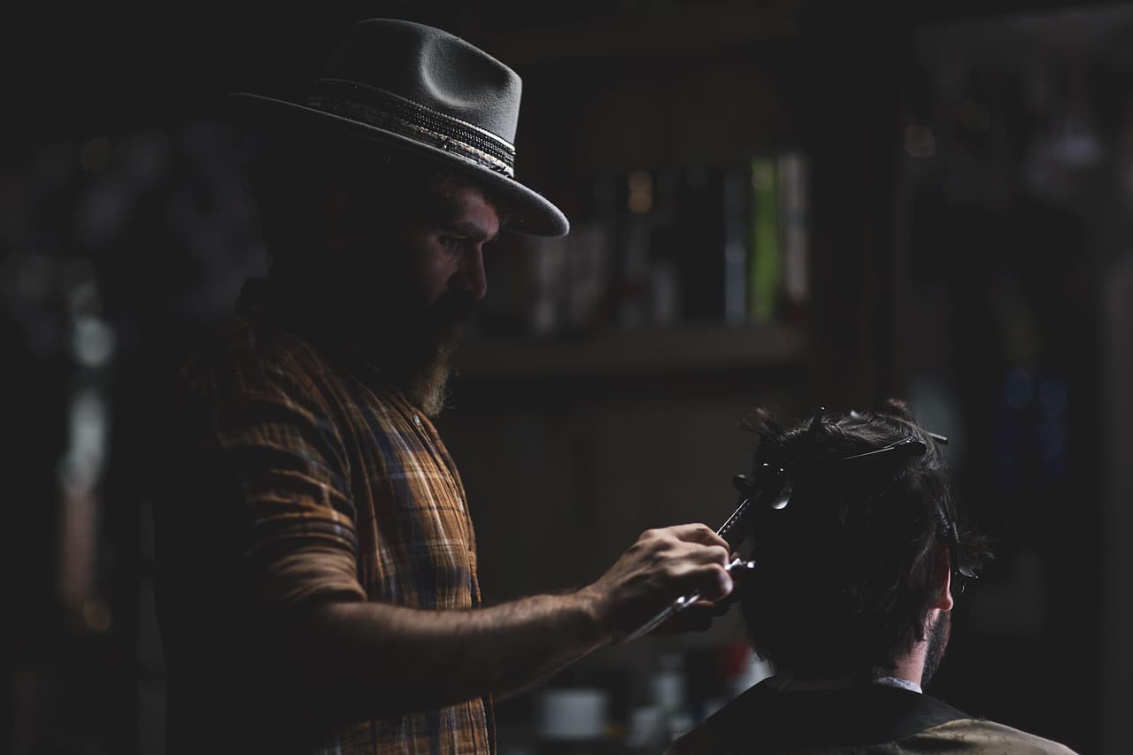 Haircut in progress with a moody editorial look