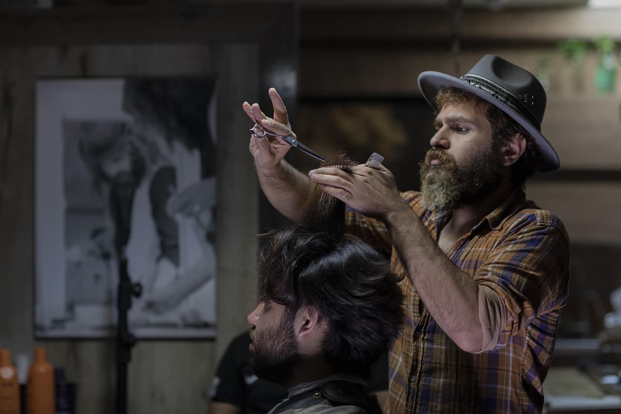 Barber shaping the neckline with clippers.