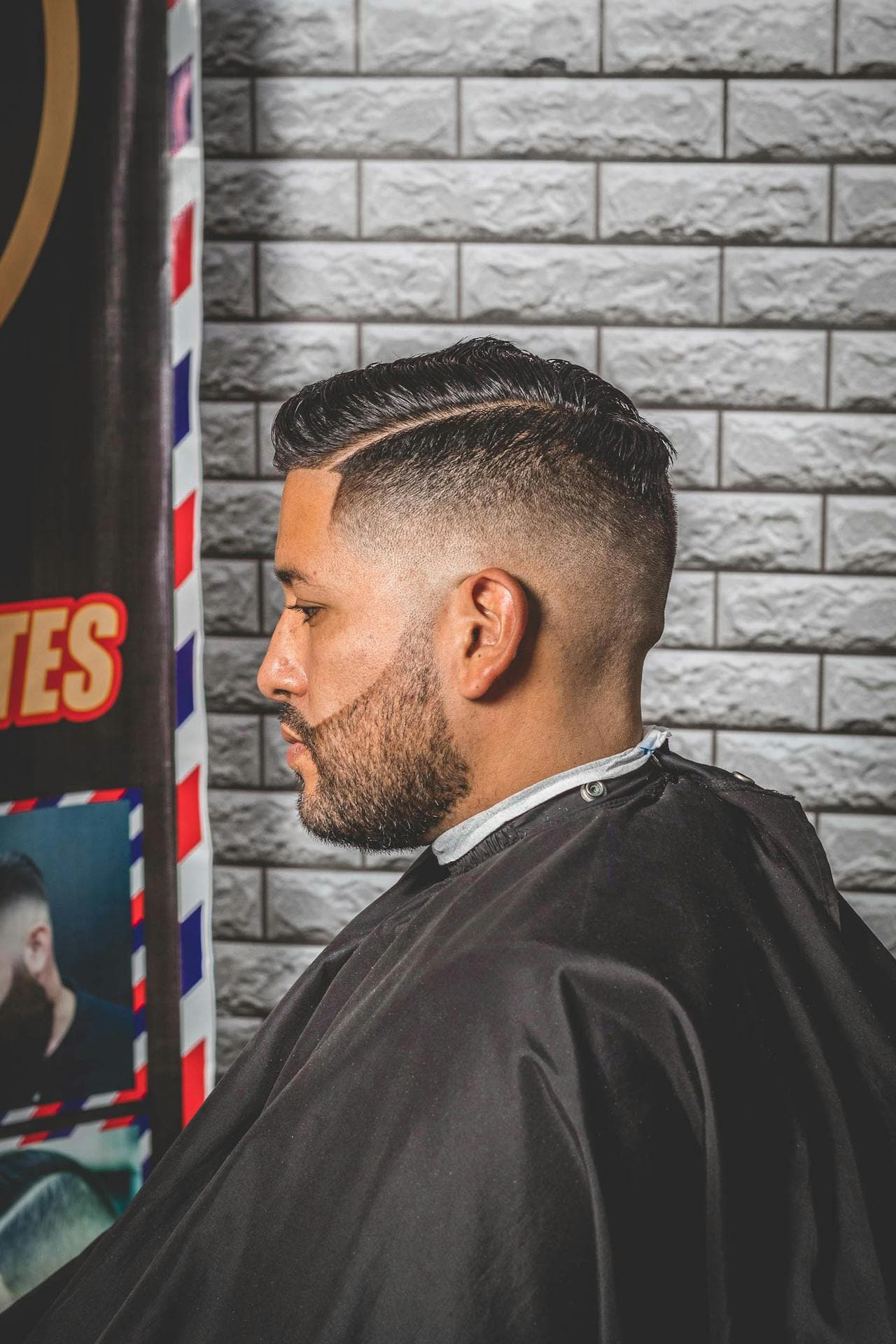 Barber cutting a child haircut with a calm finish.