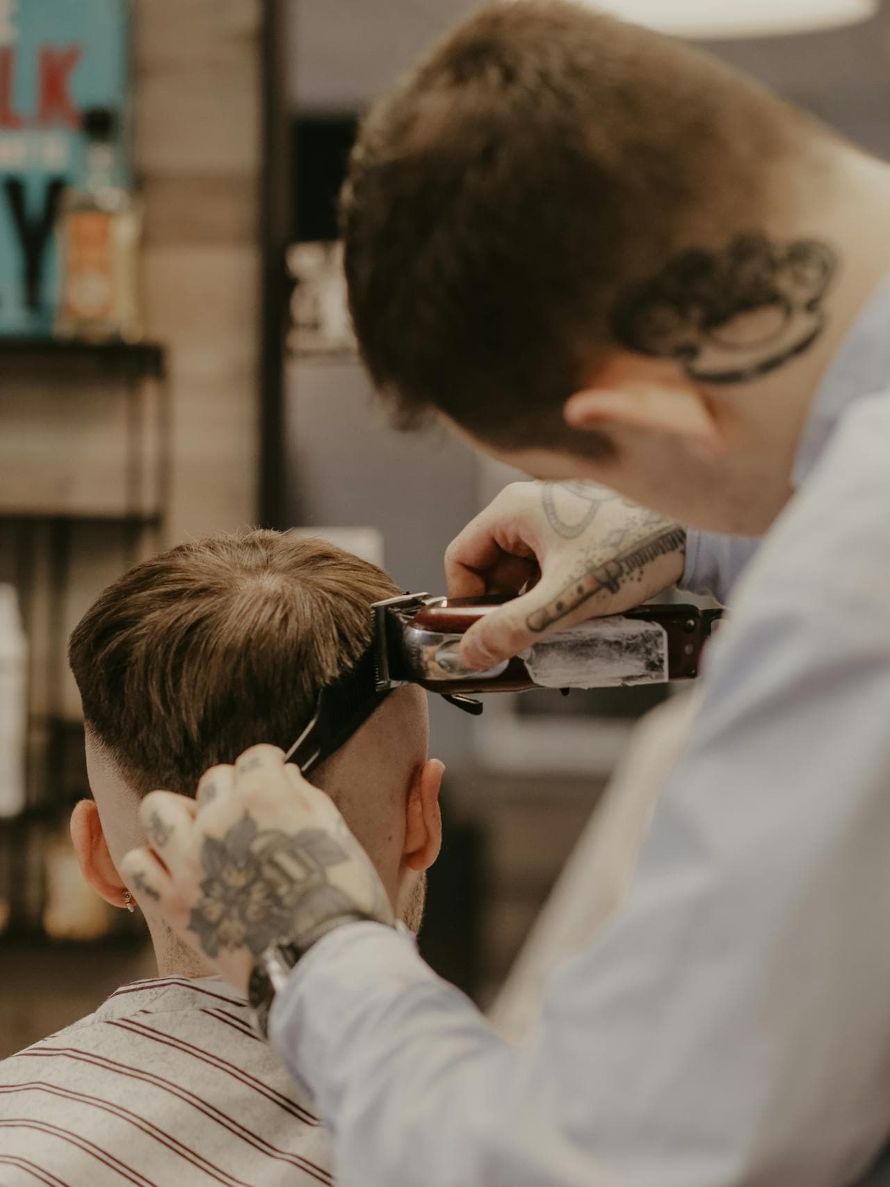 Barber balancing the top with comb and shear control.