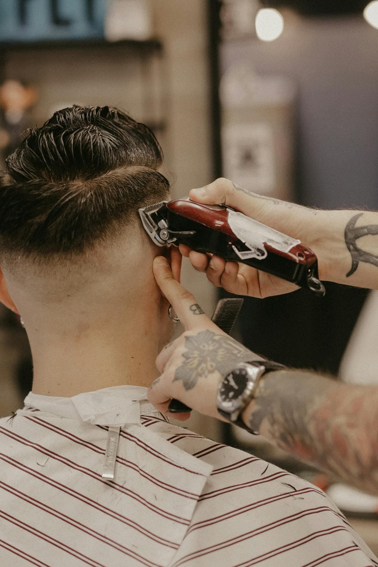Close-up of a precise barbering haircut in progress.
