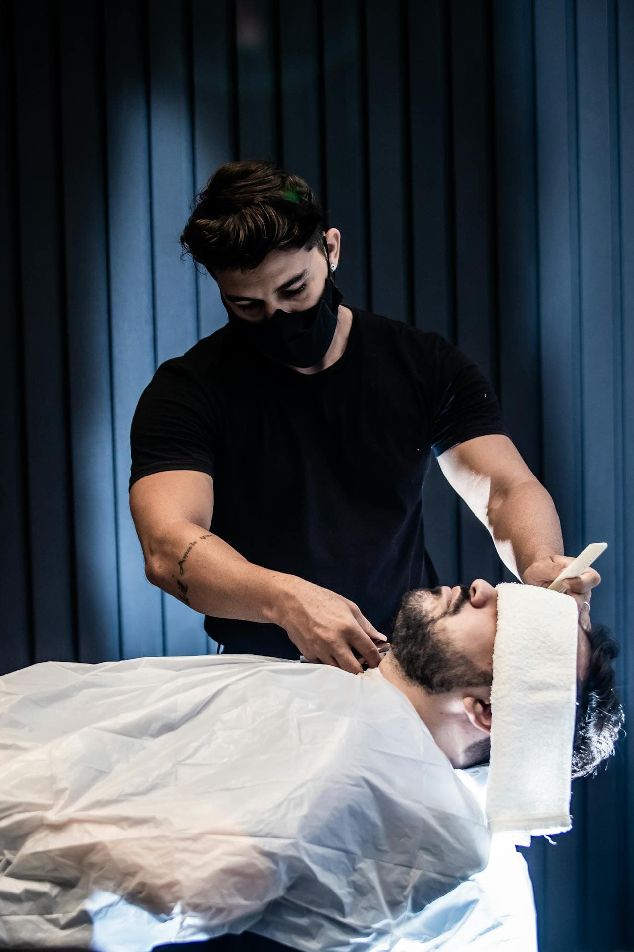 Razor service at the temple with the client reclined.