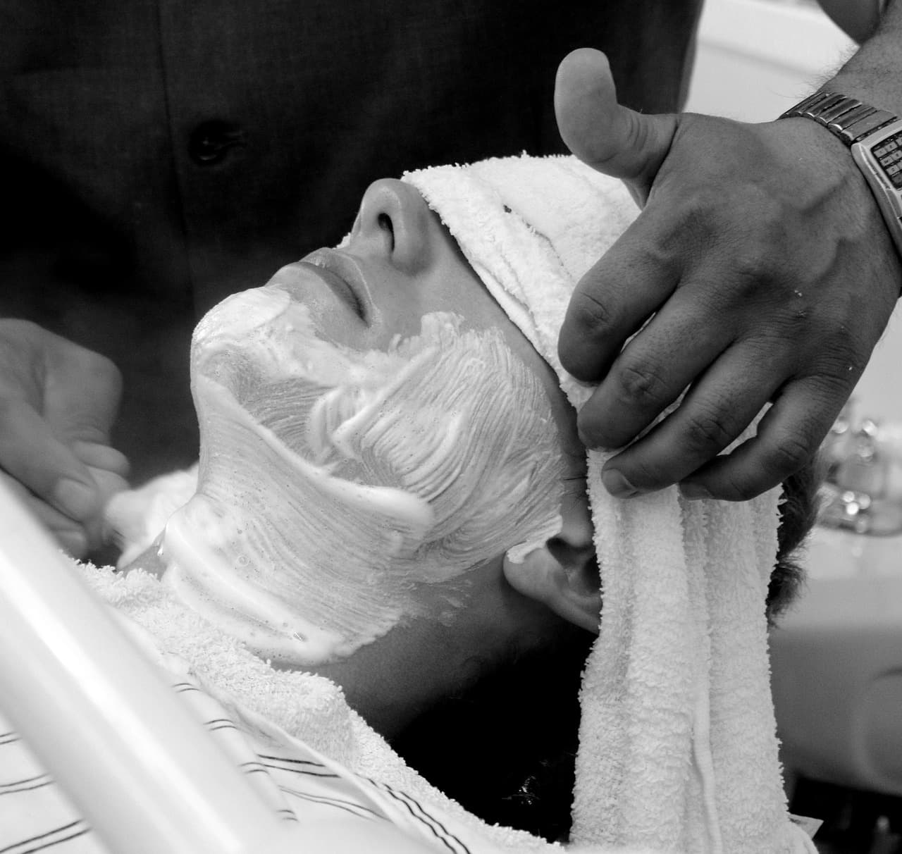 Traditional straight razor shave performed in the chair.