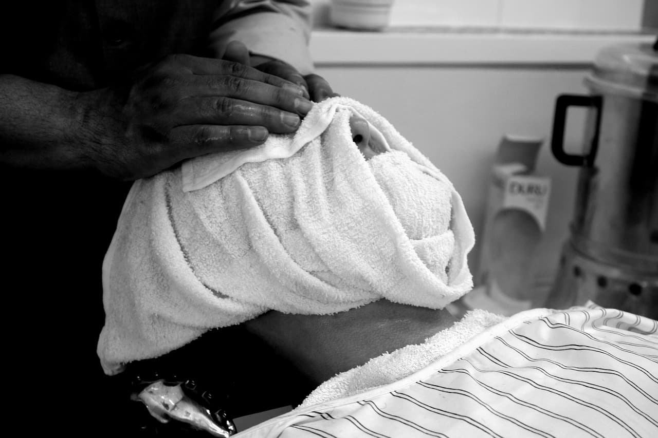 Hot towel ritual prepared for a traditional wet shave service.