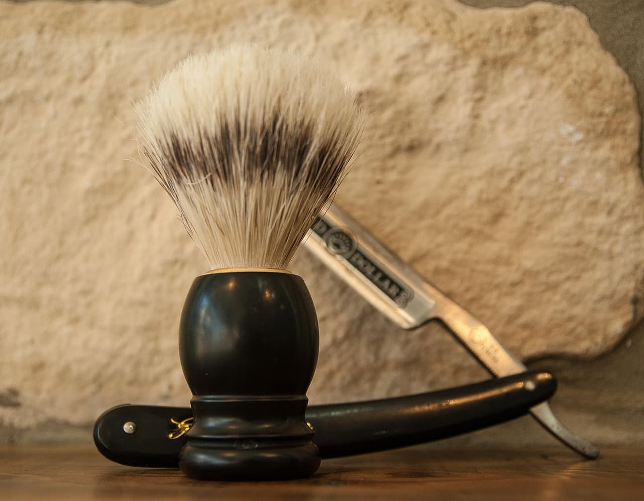 Shave brush and straight razor laid out for service prep