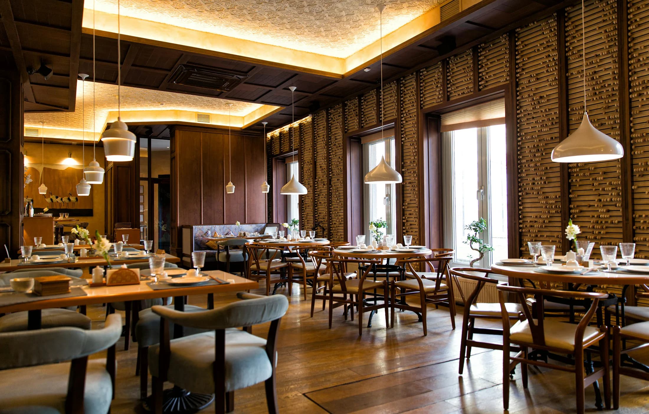 A warm dining room prepared for service
