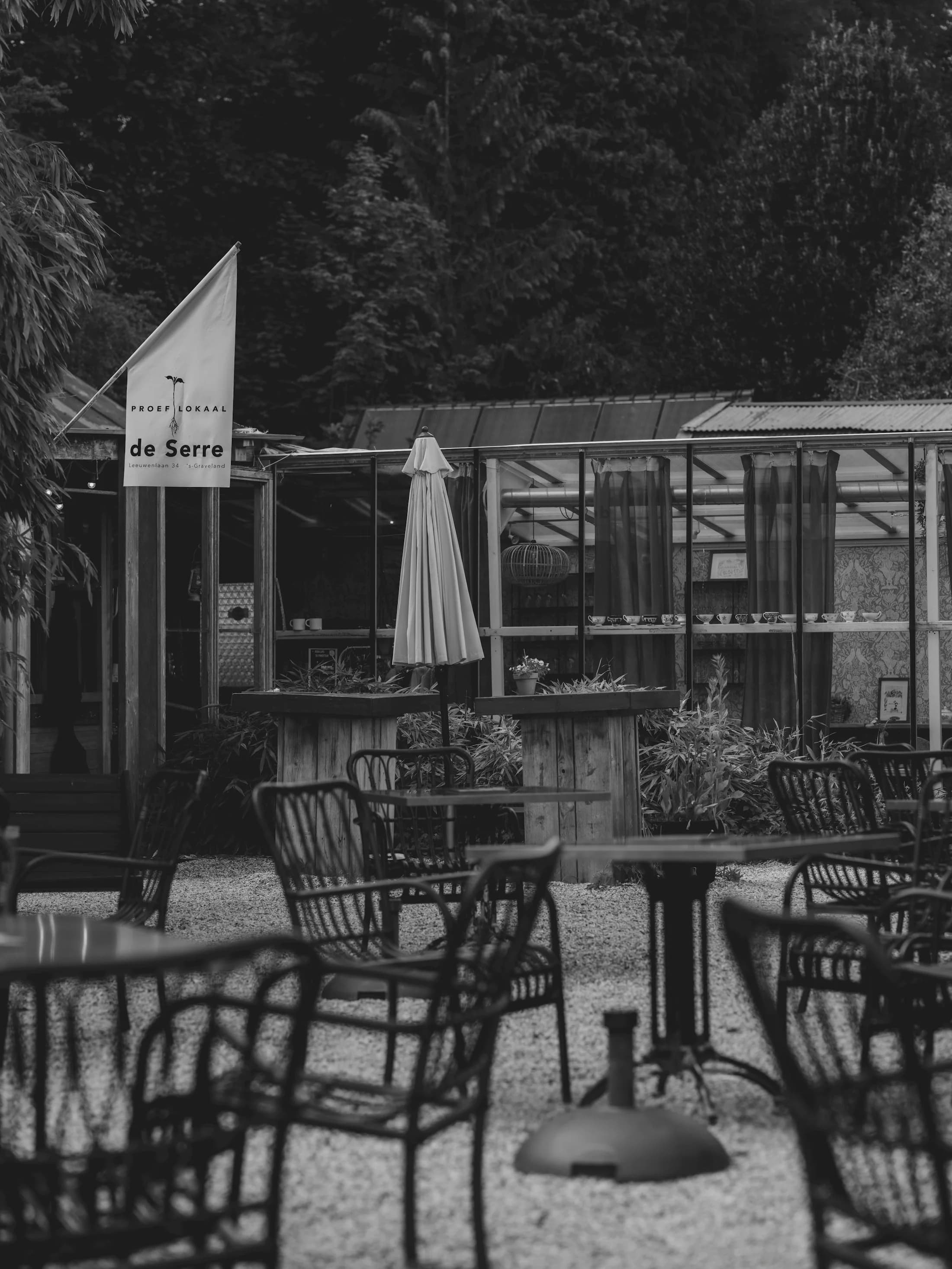 A greenhouse dining garden surrounded by trees