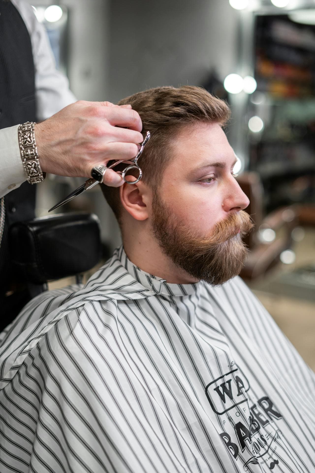 Close side-profile haircut with scissor detailing.